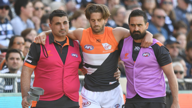 Ward is helped from the field after suffering a season-ending knee injury against Geelong.