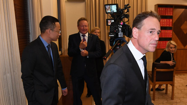 Health Minister Greg Hunt walks away from Chinese consul-general Zhou Long and Andrew Forrest after the press conference.