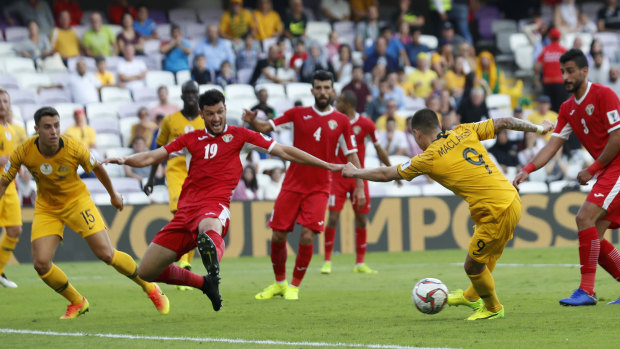 Mad scramble: Australian striker Jamie Maclaren attempts to shoot past Jordan defender Anas Bani Yaseen.