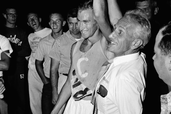 Percy Cerutty holds Elliott’s hand high after his protege ran a mile in 3:57.9 in California in June 1958.