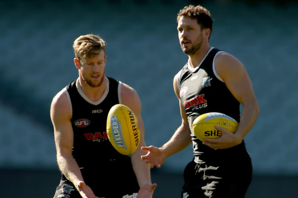 Travis Boak (right) wants a more equal travel schedule for AFL teams.