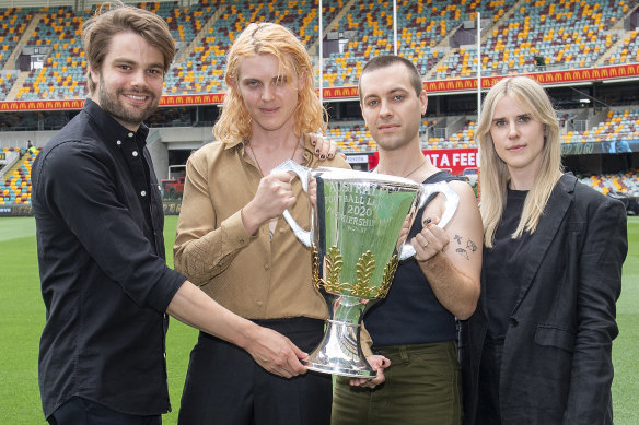 Cub Sport: Dan Puusaari (left), Tim Nelson, Sam Netterfield and Zoe Davis, with the AFL Premiership Cup.