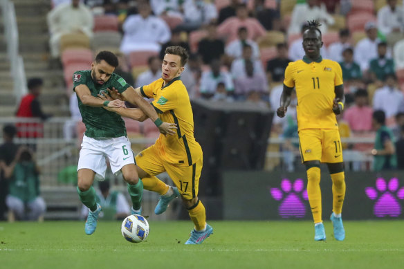 Australia’s Denis Genreau wrestles Mohammed Al-Breik for the ball in Jeddah.