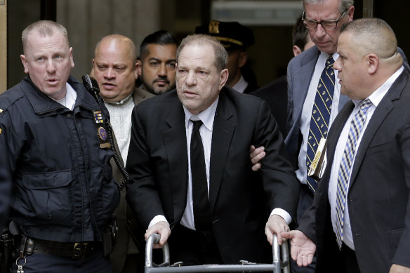 Weinstein leaves the Supreme Court in New York, using a walking frame.