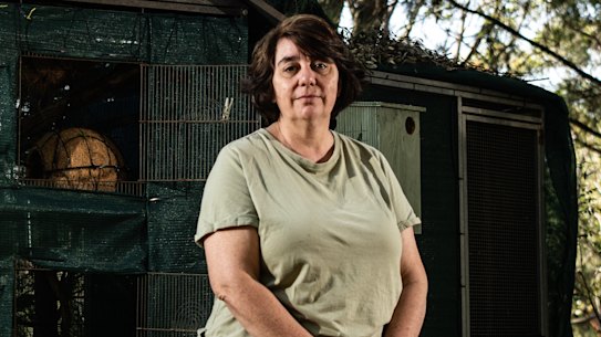 Liz Martin, a former WIRES carer who has left the organisation after 10 years, standing before now-empty rehabilitation cages for possums and gliders.
