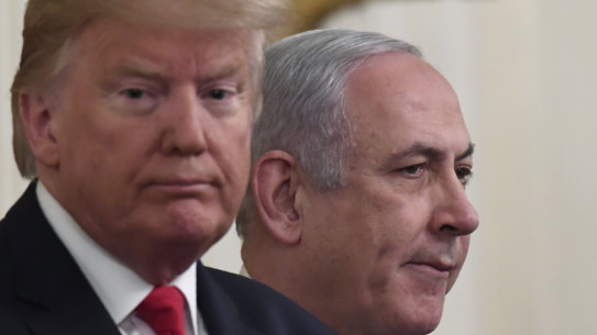 Benjamin Netanyahu applauds during Donald Trump's announcement.