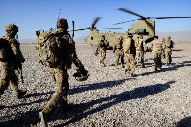 Australian troops from Special Operations Task Group and their Afghan counterparts from the Provincial Response Company walk to a CH-47 Chinook aircraft ahead of a mission.