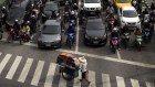  A Thai garment vendor pushes his cart crossing the pedestrian lane at a busy street in Bangkok, Thailand, 21 September 2015.