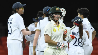 Beth Mooney walks off the field after being dismissed during day four of the women’s international Test between Australia and India at Metricon Stadium.