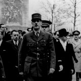 Charles de Gaulle walks down the Champs-Élysées after the liberation of Paris in August, 1944.