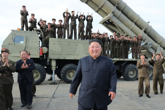 In a photo provided by the North Korean government, leader Kim Jong-un smiles at the test-firing of an unspecified missile at an undisclosed location in North Korea. 