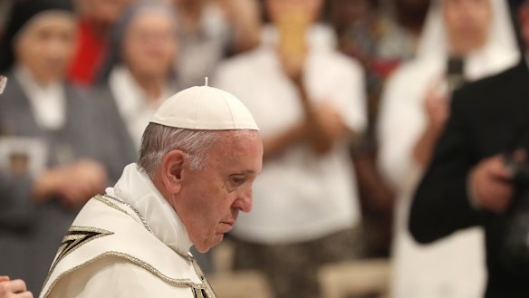 Pope Francis arrives in St Peter's Basilica at the Vatican to lead a vesper prayer.