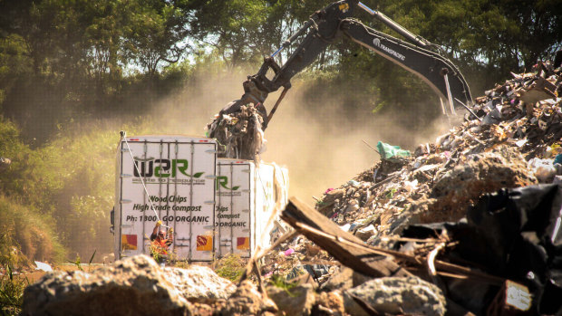 Waste from NSW being loaded into trucks at a Cleanaway facility in Queensland before being buried at New Chum. 