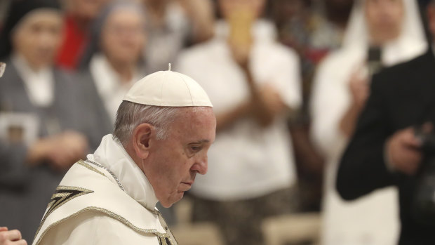 Pope Francis arrives in St Peter's Basilica at the Vatican to lead a vesper prayer.