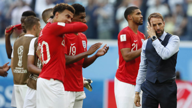 Work to do: Gareth Southgate walks among his players after their defeat to Belgium.