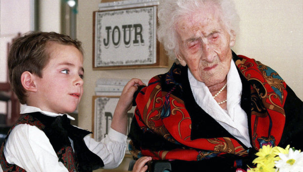 Pictured in 1997, Jeanne Calment – the oldest woman ever at 122 years and 164 days – is given flowers by a 5-year-old boy called Thomas.