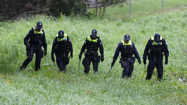 Police conduct a line search at Dandenong Creek in Bayswater on Saturday, after a man was found dead in a van on the EastLink Freeway