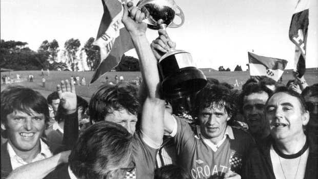 Attila Abonyi holds the NSW premiership trophy aloft after Sydney Croatia defeated Auburn in the 1977 grand final at the Sydney Sports Ground.