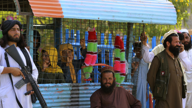 Taliban fighters stand guard on their side at a border crossing point between Pakistan and Afghanistan.