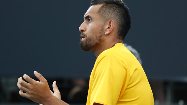 The sidelined Nick Kyrgios cheers Millman in the first set of his match against Auger-Aliassime.