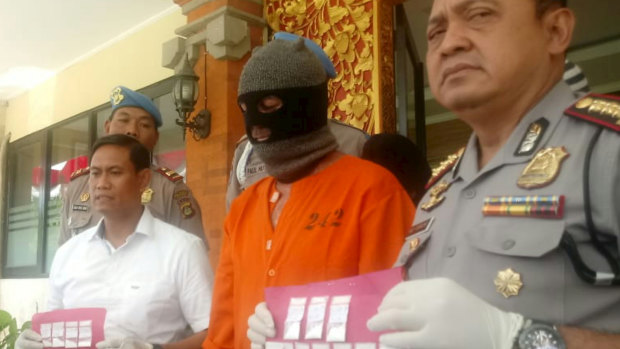 Johnsson being paraded in an orange jumpsuit by Indonesian police on Thursday at a press conference.