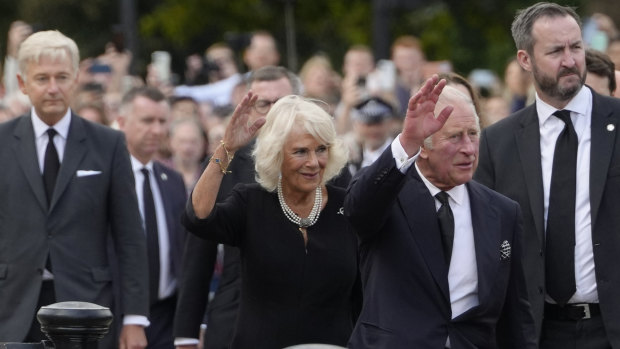 King Charles III and Camilla, the Queen Consort, wave as they arrive at Buckingham Palace in London.