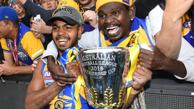Willie Rioli of the Eagles holds the premiership trophy after winning the 2018 AFL Grand Final. 