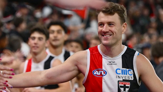 Jack Macrae of the Saints high-fives fans earlier this season.