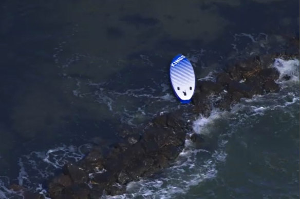 A paddleboard floats in the waters off Swan Island after the teenagers were rescued.
