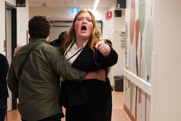 A  protester yells at the prime minister during an early campaign stop in NSW.