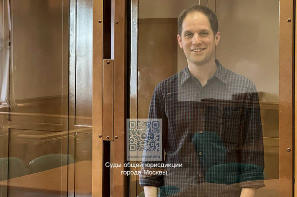 Wall Street Journal reporter Evan Gershkovich stands in a glass cage in a courtroom at the Moscow City Court in March.