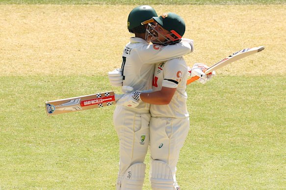 Alex Carey of Australia congratulates Travis Head of Australia after scoring a century.