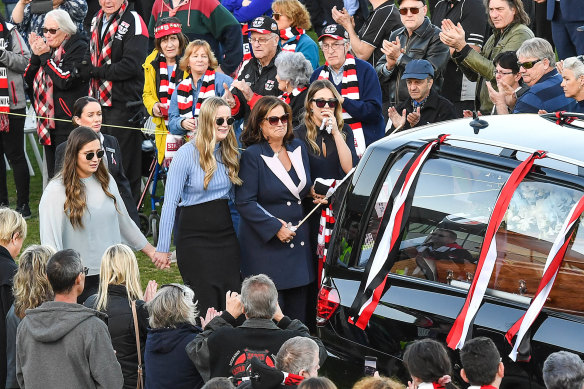 Danny Frawley's wife and daughters walk behind his hearse at Moorabbin Oval.