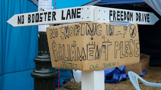 A signpost is erected outside a tent during a protest at Parliament in Wellington, New Zealand, on Wednesday.