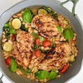 White beans and seasonal vegies add substance to this one-pan chicken dish.