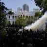 Police use teargas as Sri Lankan protesters storm the compound of prime minister Ranil Wickremesinghe’s office, demanding he resign after president Gotabaya Rajapaksa fled amid economic crisis in Colombo, Sri Lanka, on Wednesday.