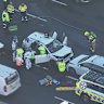 Emergency services attend to a patient with back injuries after a head-on collision on the Sydney Harbour Bridge.