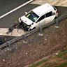 The man and car were struck when waiting at a Logan Motorway emergency bay.