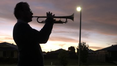 Dale Munckton, playing 'The Last Post' from his driveway at Cowes, Phillip Island.