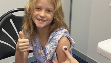 Lucy McDonnell, 10, receives her first dose of the COVID-19 vaccine at Cairns Convention Centre. 