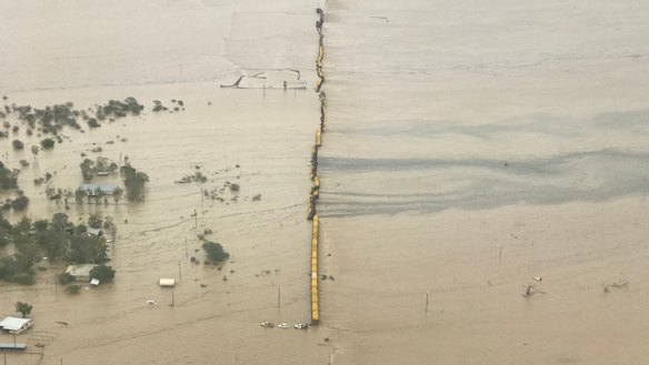 The aerial view of the train with wagons flipped over and what appears to be a chemical slick.