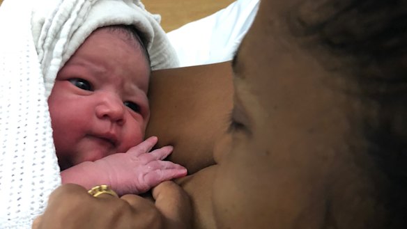 Amrita Kapur holding Ishani after giving birth. 