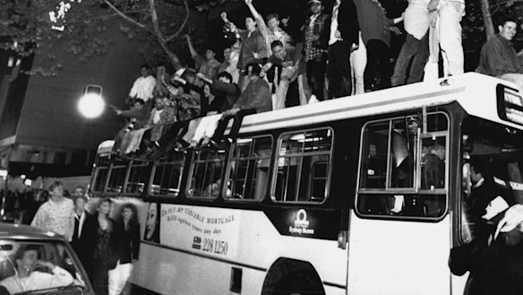 Sydneysiders celebrate on top of a bus in George Street after the announcement in Monte Carlo. September 24, 1993. 