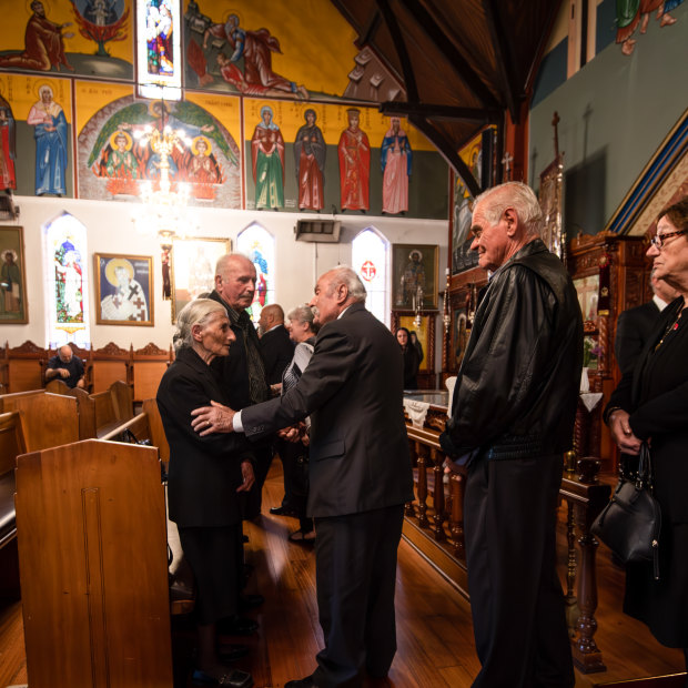 Effie is comforted by family and friends at her husband Apostolos’ funeral service at St Eleftherios Church in Brunswick.