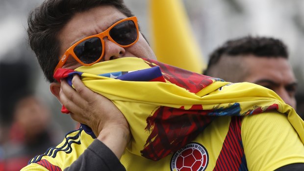 A Colombian fan shows his disappointment.
