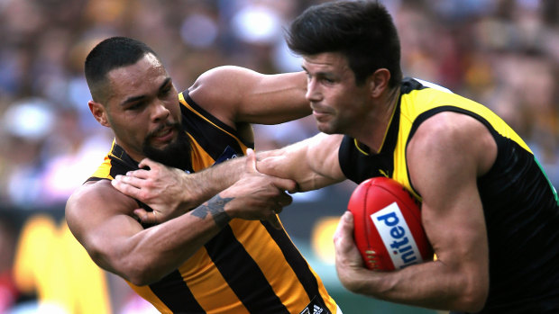 Trent Cotchin fended off Jarman Impey when the Tigers and the Hawks met earlier this season.