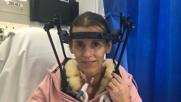 Keri Frecklington several weeks after the surgery with her head brace and tracheotomy tube.
