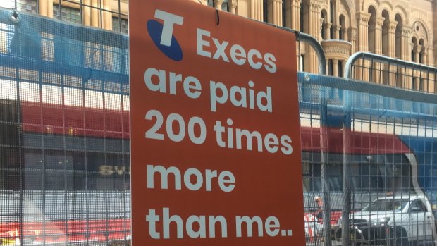 Union signs outside the front of the Telstra AGM in 2018.