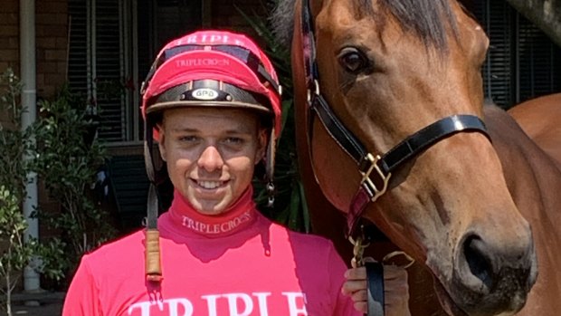Jockey Andrew Adkins with Golden Eagle runner Military Zone in the pink silks Triple Crown will use for the month to help raise money for the McGrath Foundation.