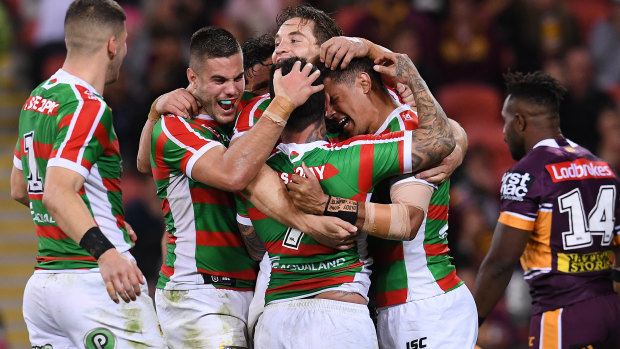 Reignited: Rabbitohs players celebrate a try during their dramatic win over the Broncos.